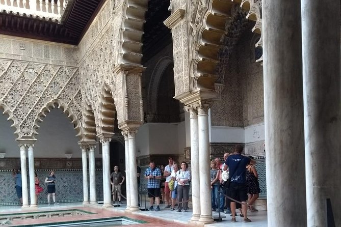 Alcazar of Seville with Cathedral & Giralda English Tour - Inside the Alcázar: courtyards, arches, and royal rooms