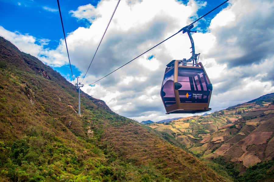 From Chachapoyas: Kuelap Fortress and Cable Car Tour - Taking the cable car toward the mountaintop city
