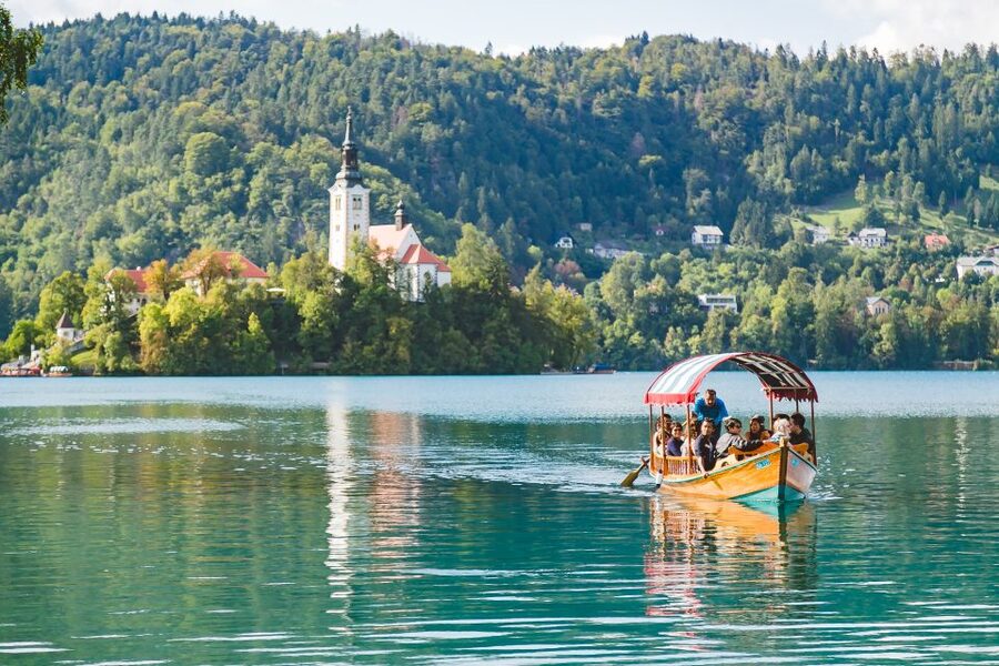 From Ljubljana: Lake Bled and Bled Castle Tour - Crossing Lake Bled in a traditional Pletna